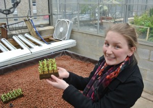 Goucher College freshman Emily Timothy shows off the seedlings that the campus Ag Co-Op will grow in the spring with a student-made hydroponic system
