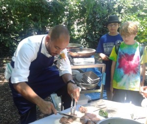 Chef Wil Fernandez-Cruz prepares grass-fed beef tenderloin and kohlrabi salad for a special lunch at camp. 