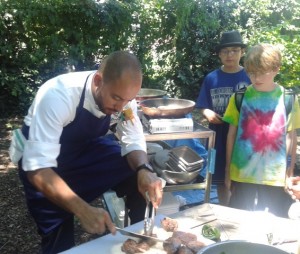 Chef Wil Fernandez-Cruz prepares grass-fed beef tenderloin and kohlrabi salad for a special lunch at camp.