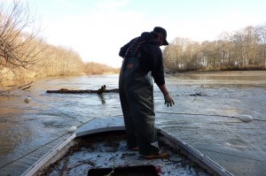 Quinault Tribal Fisherman, Archie, goes out on the Humtulip River to pick up his last catch of the day, a salmon caught in the gill net.