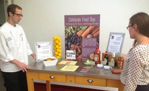 A Bon Appétit chef with a test run of the sodium-campaign information table for Food Day