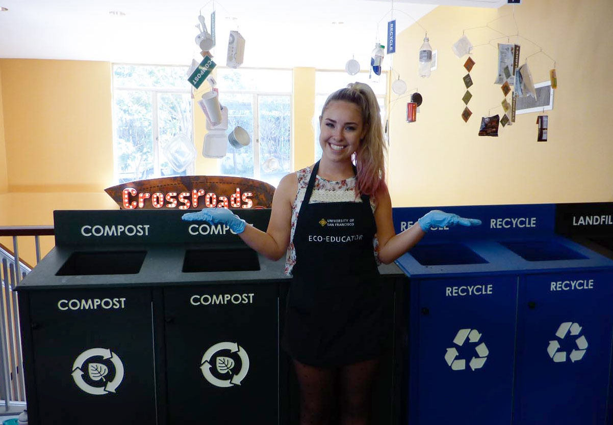 USF student Kathleen Shelton helps guests sort their waste into the right bin