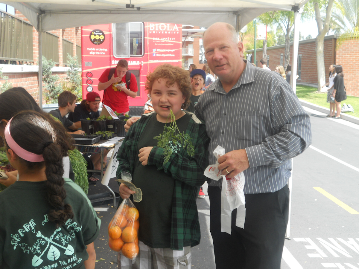 General Manager Steve Rall spots one of the elementary school students snacking on radishes and carrots like they’re candy