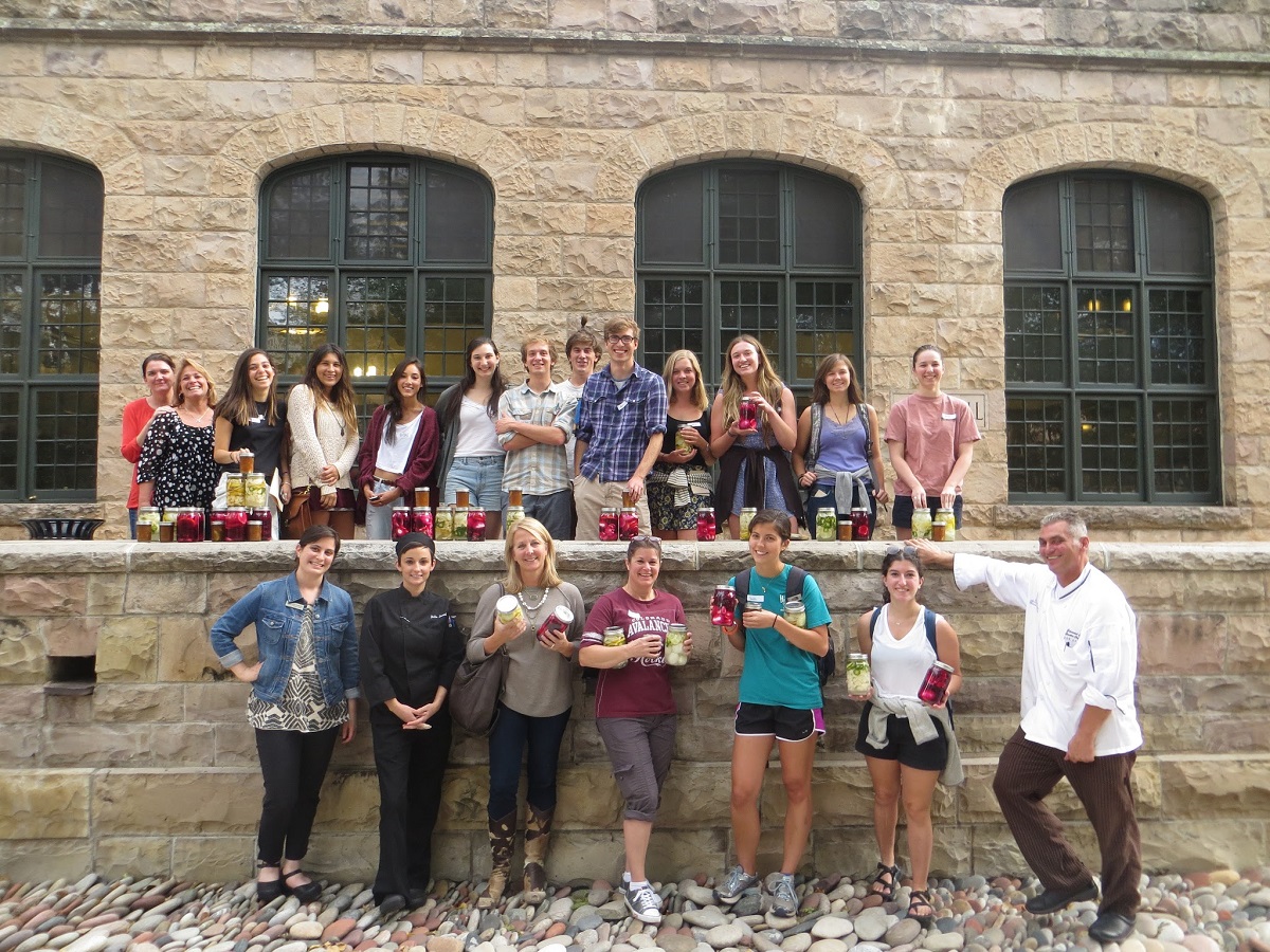 Colorado College students and staff show off the pickles and preserves they created in their food preservation class with Executive Chef Ed Clark and Sous Chef Jackie Lovecchio.