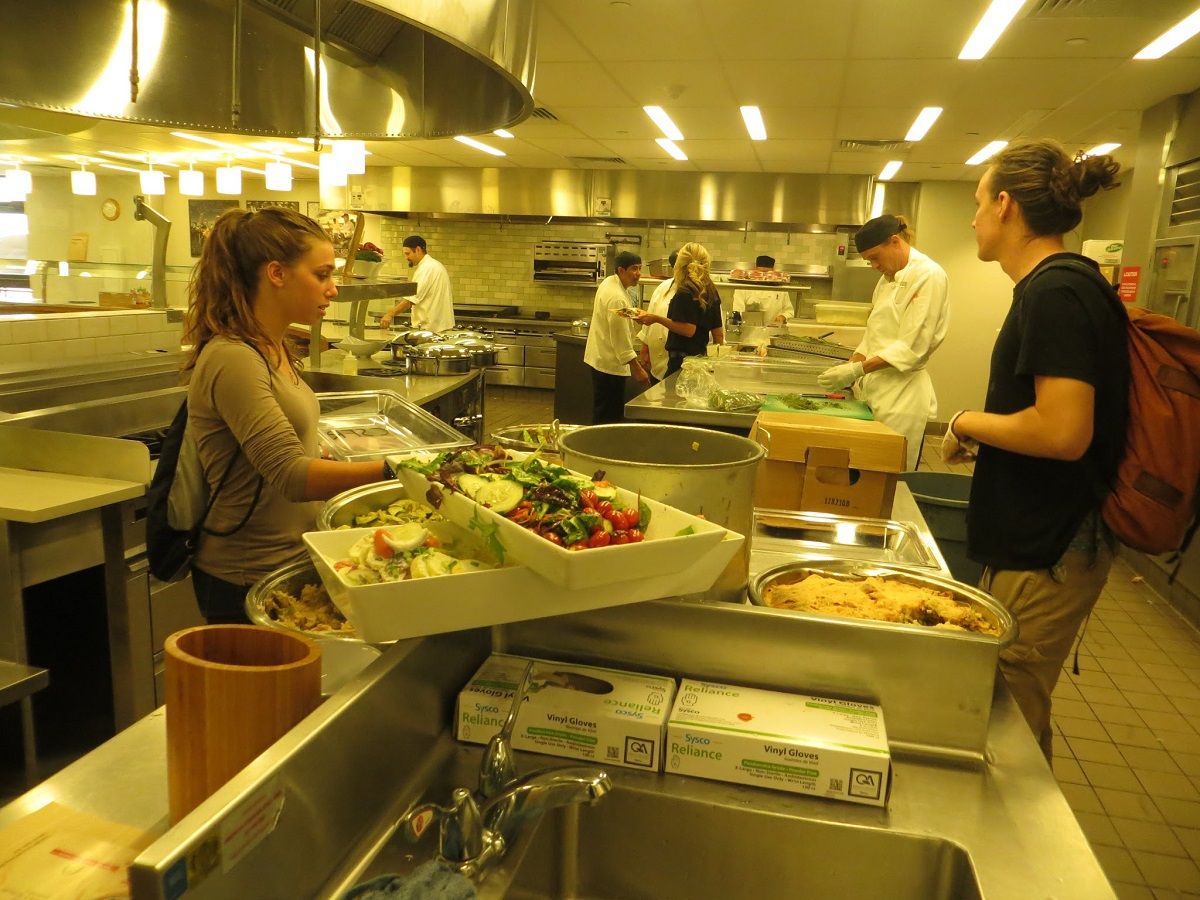 Jamie and Shane package and weigh the prepared food leftover from lunch that is safe to eat but can no longer be served in the café.