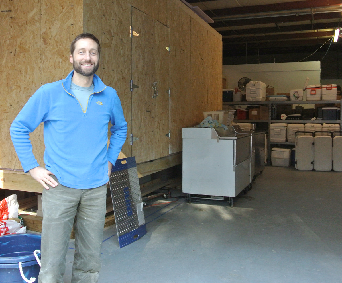 Ryan Speckman, owner of Locals Seafood, in front of the walk-in cooler that he designed and built using the $5,000 Fork to Farm grant the company was awarded this past September.