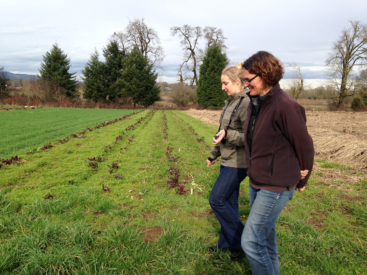 Shari and Claire chat as they walk between the winter cover crop rows