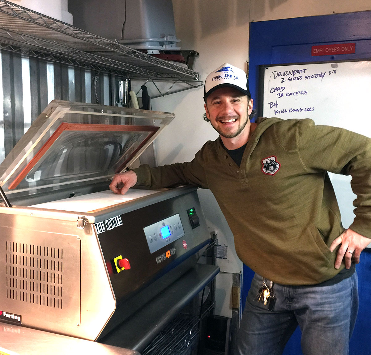 Lyf Gildersleeve poses with his new vacuum-packing machine