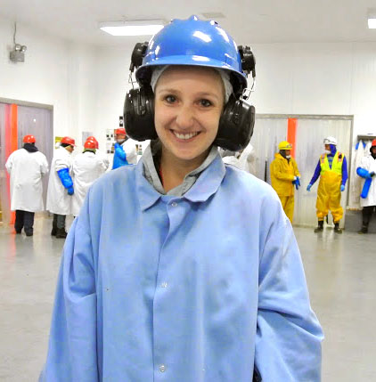 Bon Appétit Waste Specialist Claire Cummings at Church Brothers' processing facility in California, looking at products that could be rescued for the Imperfectly Delicious program.