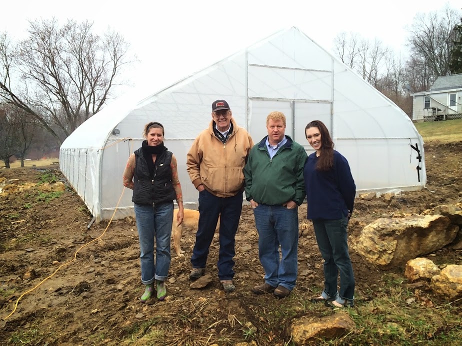 From left to right--Catherine Halliday and Matt Couzens of Horse Listener's Orchard, Don Fitting and Stephanie Keith of Roger Williams University BAMCO team-- standing outside the hoop house made possible by the Fork to Farm grant.