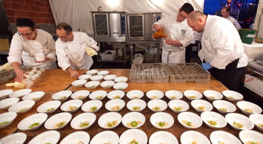 The Bon Appétit team preparing the soup, which was served in an innovative way: bowls with parsley pesto awaited guests at the table when they sat down, and then servers poured hot parsnip soup from pitchers into each bowl