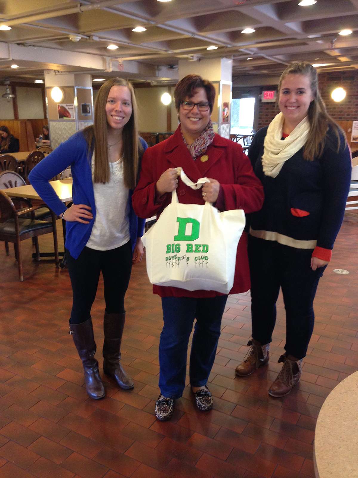 Buyer’s club creators Emily Marguerite and Jen Curry with their first customer, Liz Barringer-Smith, sporting her sweatshop-free reusable bag