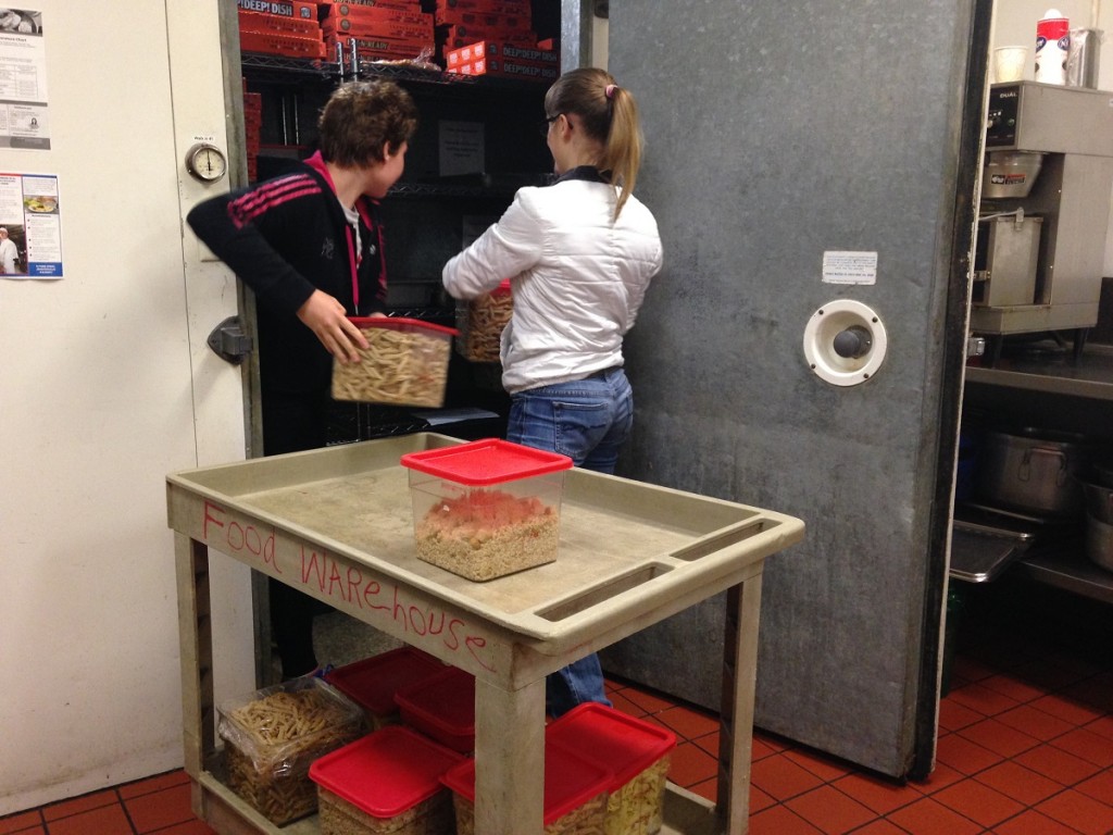 Unloading the food into the Union Gospel Mission's walk-in refrigerator