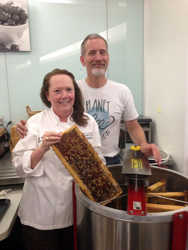 Executive Chef Melissa Miller with Bill Tomaszewski of Marin Bee Company, collecting SAP's first honey harvest