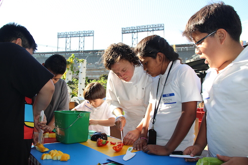 Traci demonstrates knife safety for the kids. Photo courtesy of Kelly McLain/Boys & Girls Club