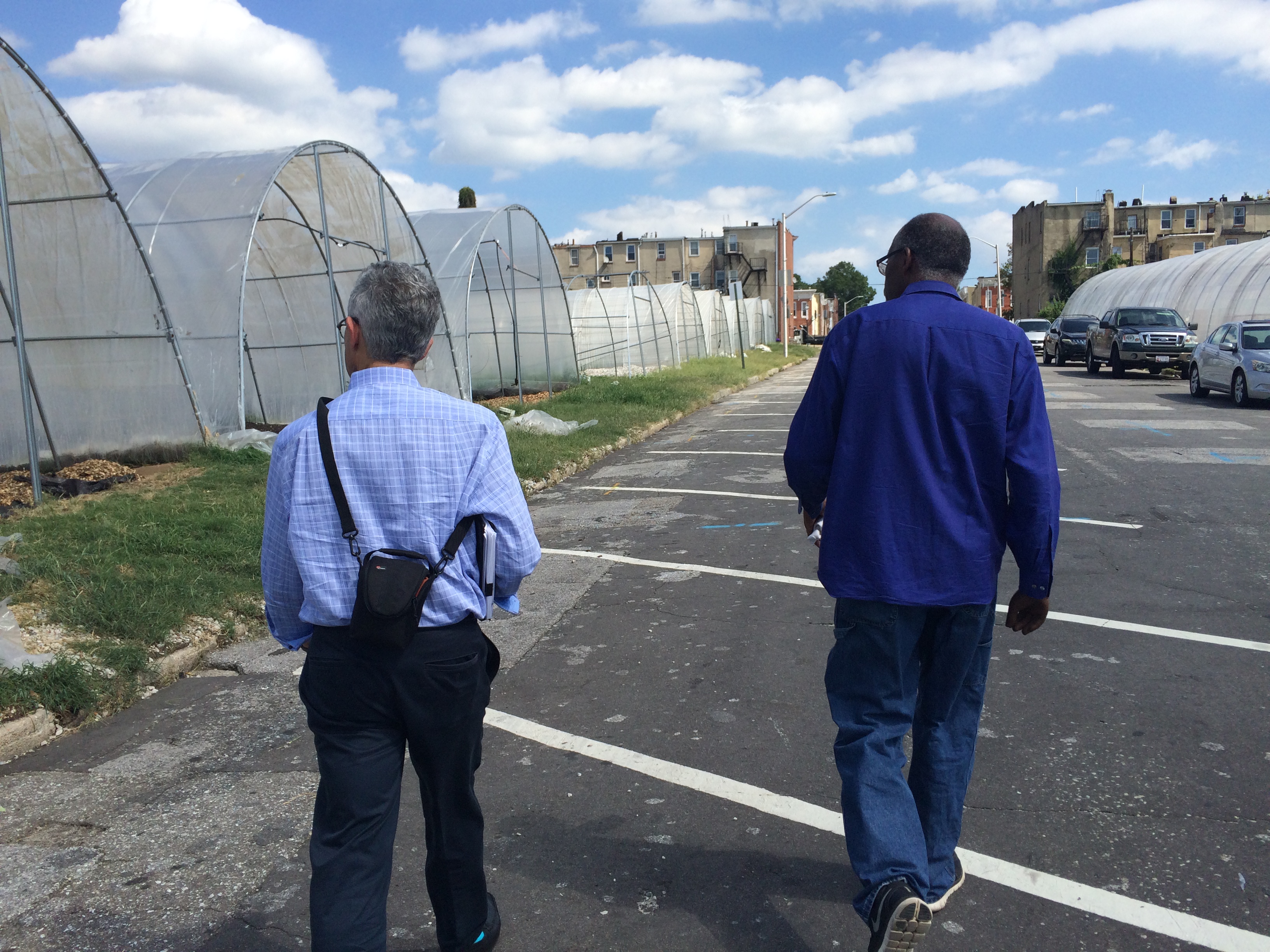 Regional District Manager Norman Zwagil tours Strength to Love II Hoop Houses with the farm's sales manager, Wendall Holmes
