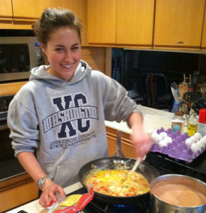 Maggie making migas, a Tex-Mex dish of torn tortillas, scrambled eggs, and vegetables