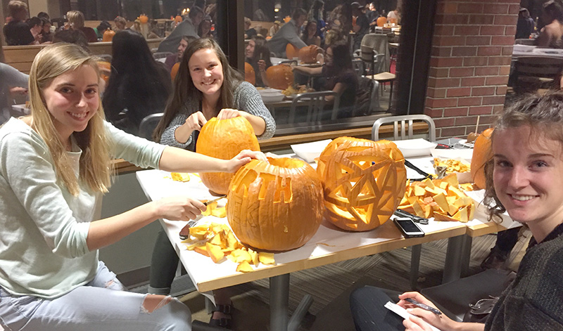 Students at Colorado College carving pumpkins