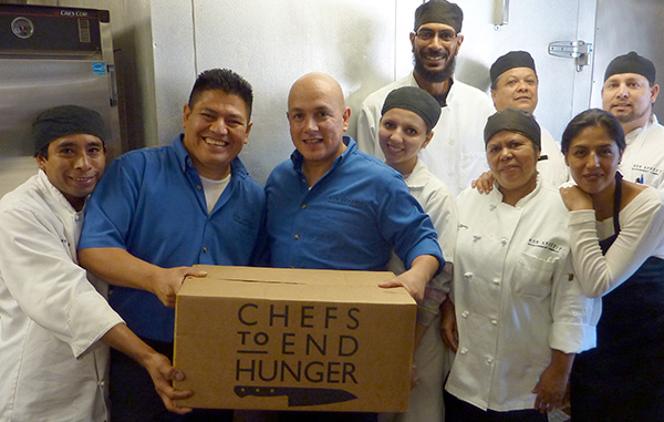 Chefs holding food donation box