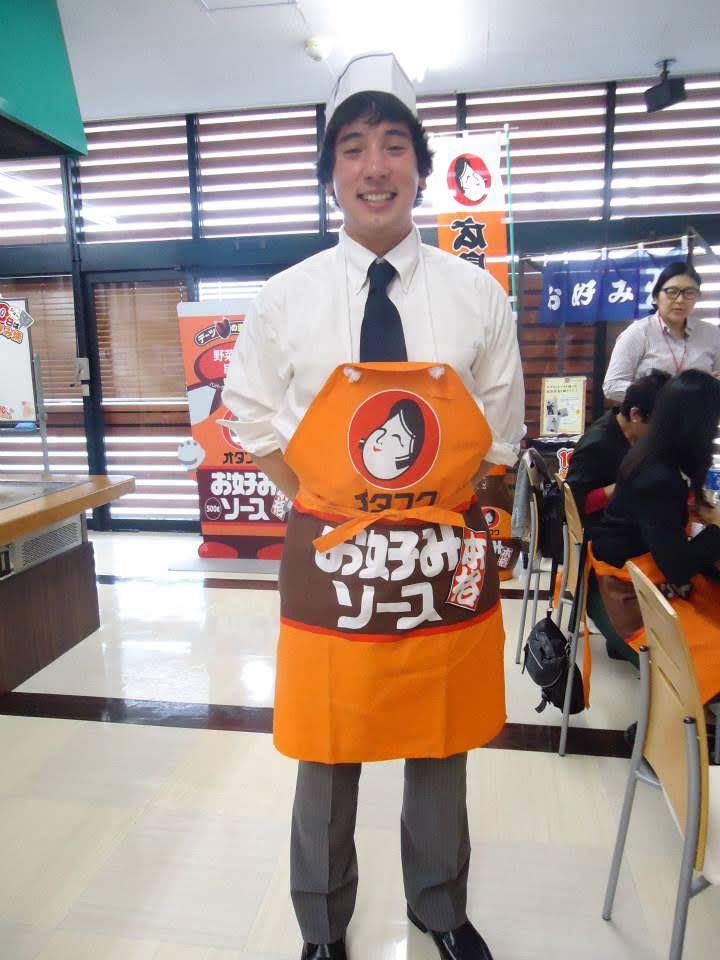 Yung man in apron with Japanese characters