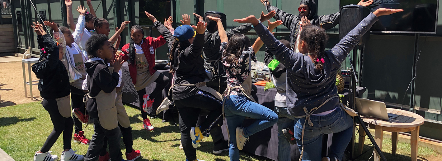 DJ Cavem leads group stretches with students from Enchantment Institute