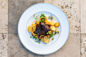 Barolo-braised Wagyu beef cheeks with roasted new potatoes, crisp Vidalia onions, spring peas, and heirloom carrot purée