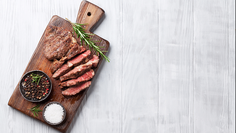 Grilled beef steak with spices on cutting board