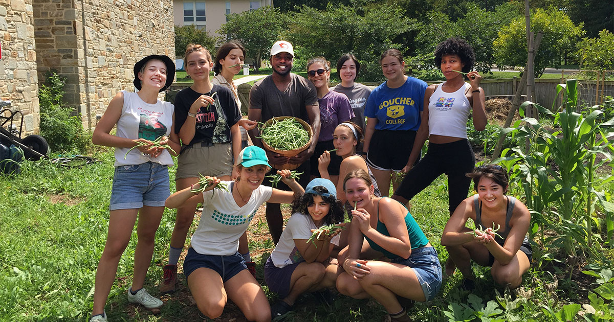 Students clowning around in a garden