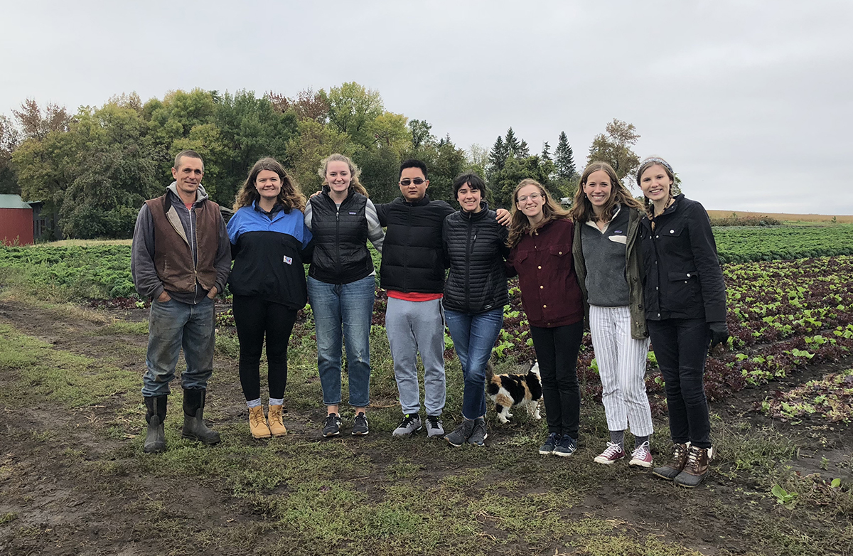 Open Hands farmer Ben Doherty and St. Olaf students