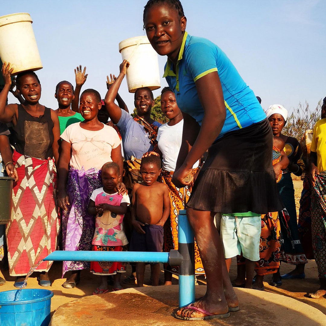 young woman pumping water