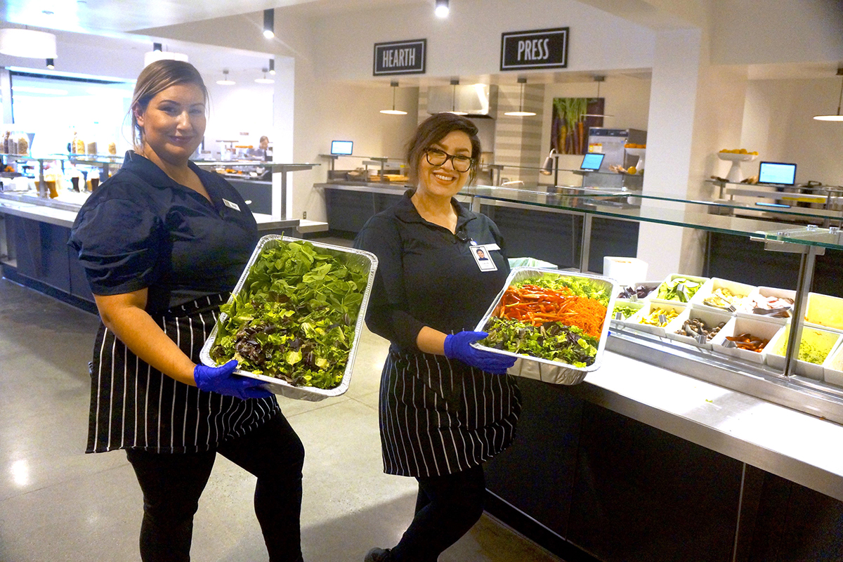 Cashiers Emily Cuevas-Barba and Laura Perez with some recovered FireEye salad bar items destined for the Wildlife Center of Silicon Valley