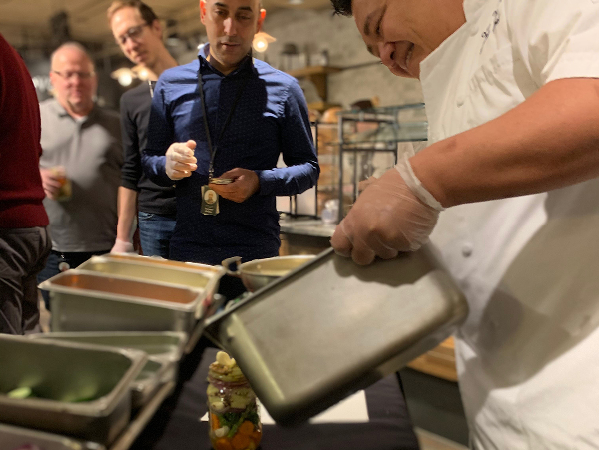 Executive Chef Vuong Loc carefully tips the brine into a vegetable-packed jar as Starbucks