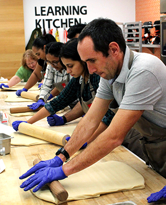 Students rolling dough