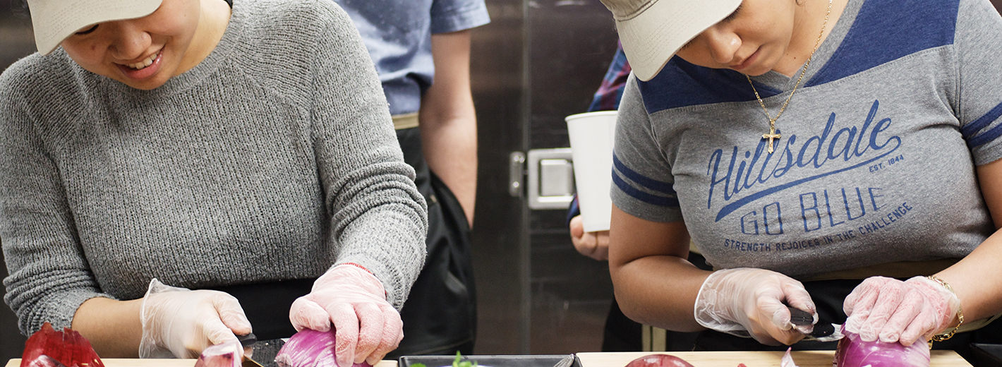 Hillsdale students learning to cut onions efficiently