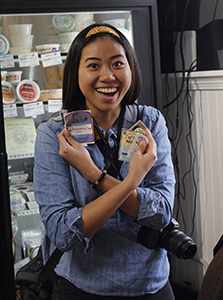 Student Danielle Lee holding up stickers from Zingerman’s Creamery