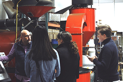 Zingerman’s Coffee Company and Candy Manufacturing Managing Partner Steve Mangigian discusses operations with Hillsdale student Danielle Lee, AJ’s Supervisor Lisa York, and Marketing Coordinator William Persson