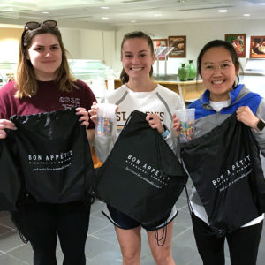 Girls holding bags and smiling