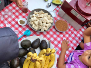 Avocados, bananas, and hands 