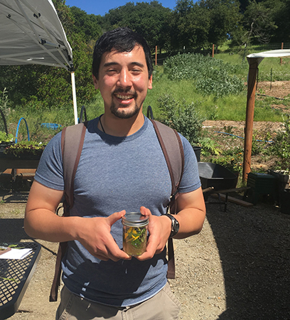 Fellow Taiyo Scanlon-Kimura with a Mills Campus Farm tonic of freshly picked herbs and apple cider vinegar