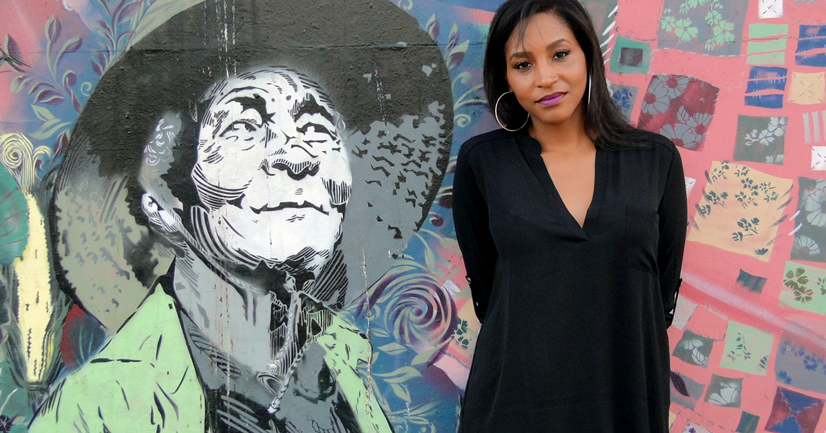 Nikki Cooper in front of a mural