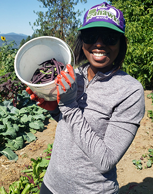 Nordstrom Operations Manager Dorian Gossom harvests peas