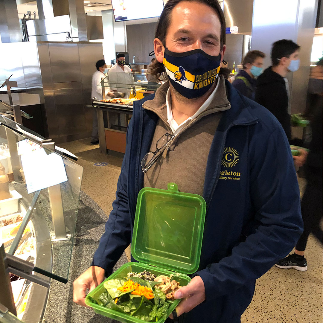 Man wearing mask and holding food to go