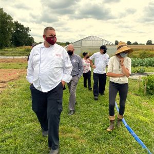 Chefs and staff touring a farm