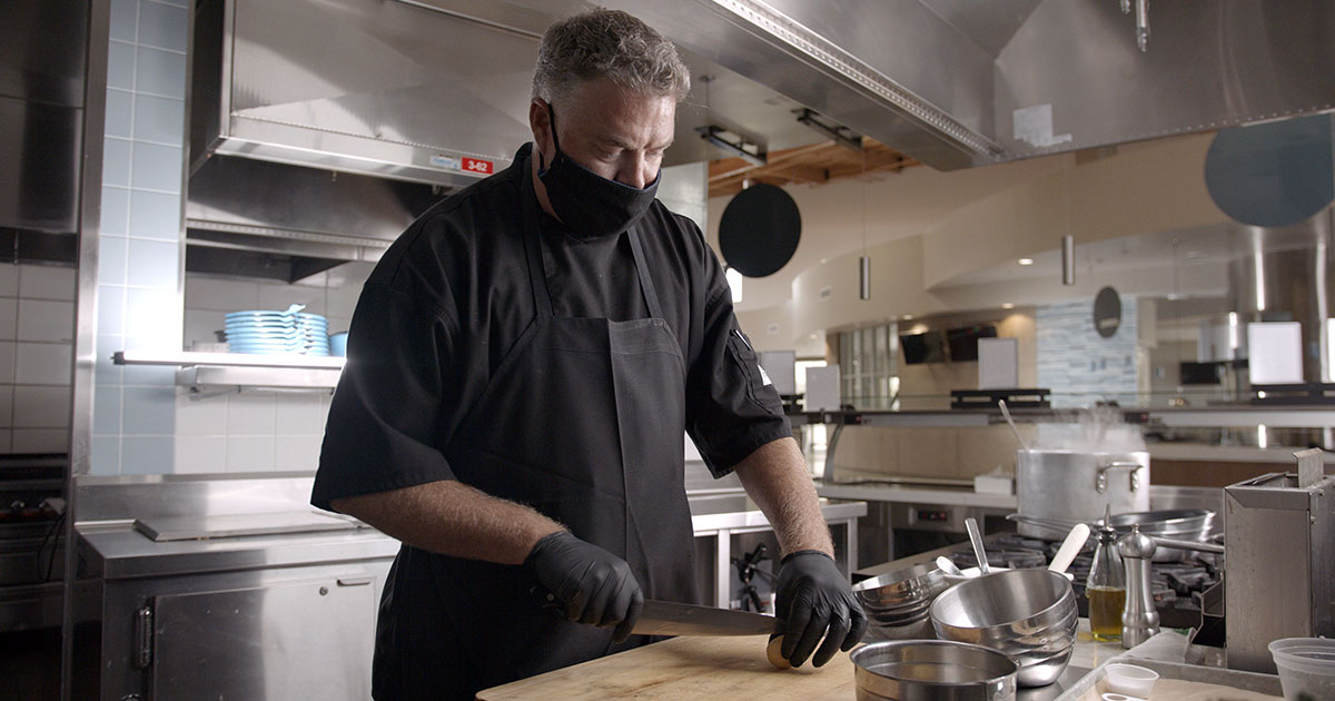 Masked chef in a kitchen