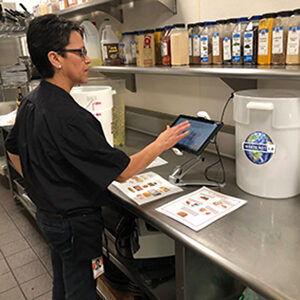 A Bon Appétit culinary team member uses Waste Not to quickly calculate food waste.