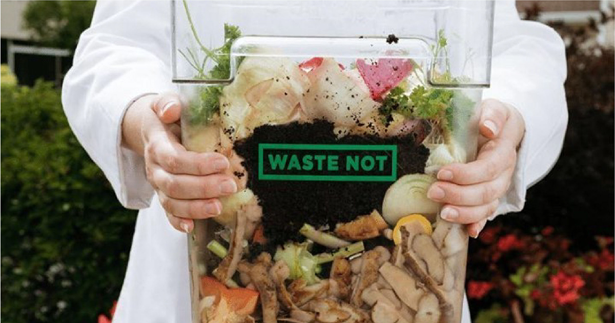 Clear container holding compostable waste with words "Waste Not" on it.