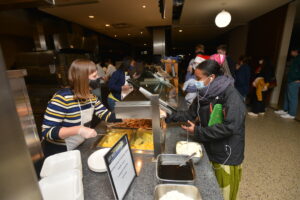 Dr. Byerly serves a student during Carleton’s post-inauguration midnight breakfast. Credit: Carleton College