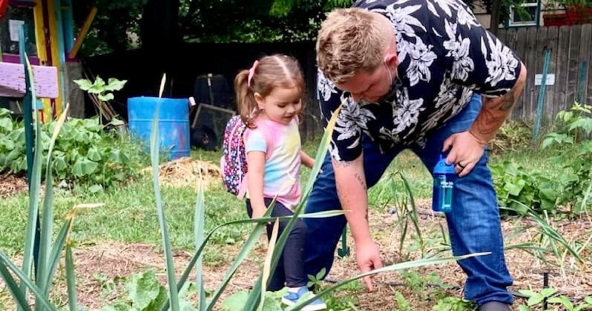 Executive Chef Jon Sodini and his daughter weed at the garden