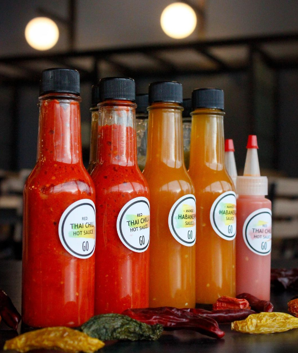 Hot sauces made with garden-grown ingredients on display at Whitman’s Cleveland Commons