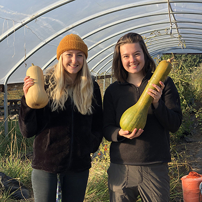 Willamette University Farm Club student leaders Hope Heideman and Arabella Wood with some Zena-grown squash